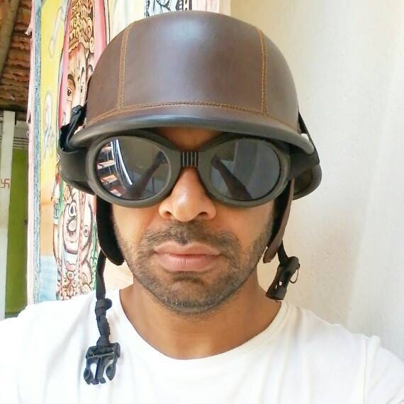 Akram Khan in a leather aviator helmet and goggles