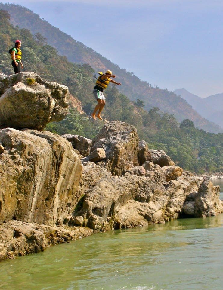 Akram Khan cliff jumping into the river during a rafting trip