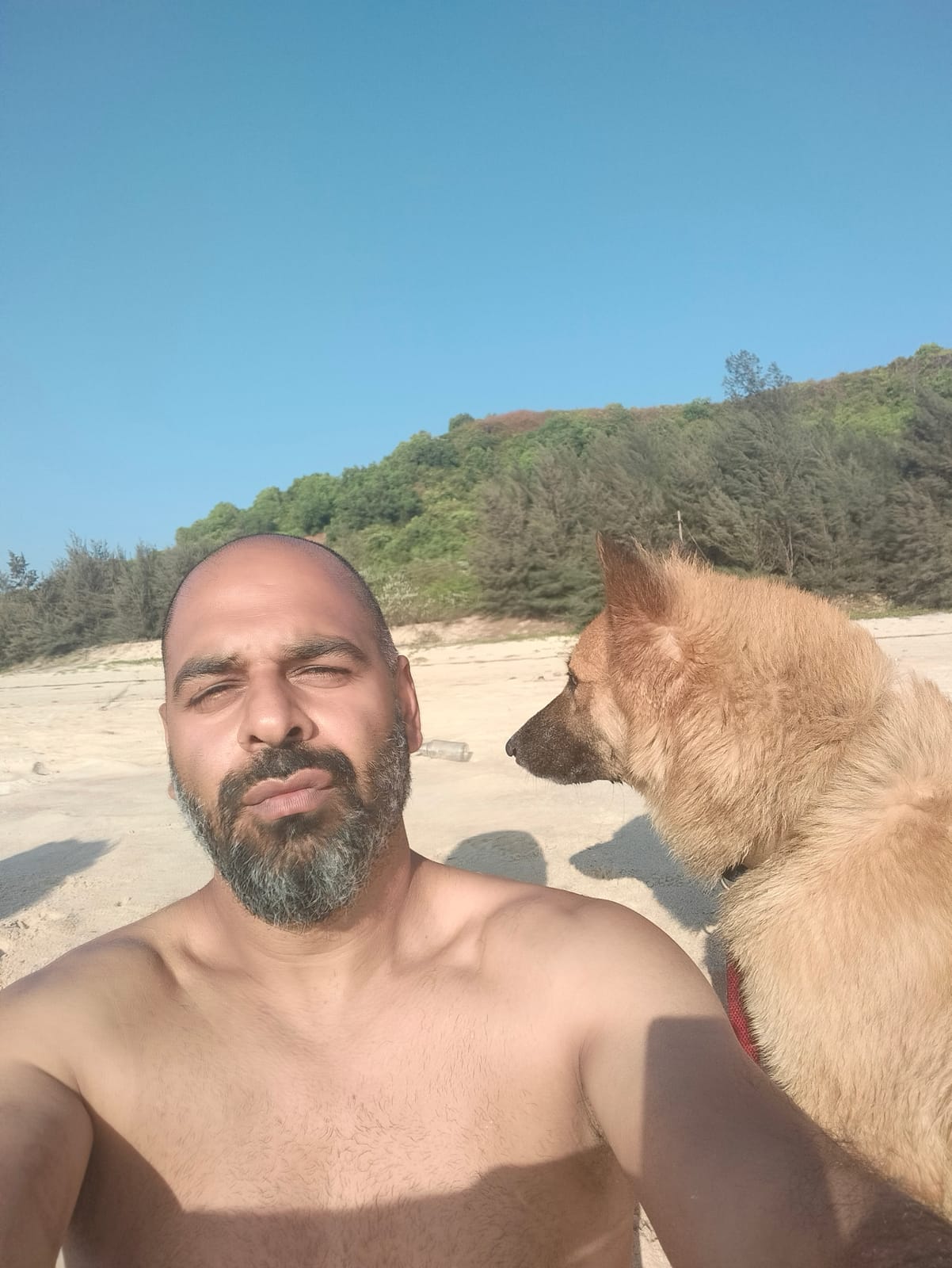 Akram Khan with a dog on the beach