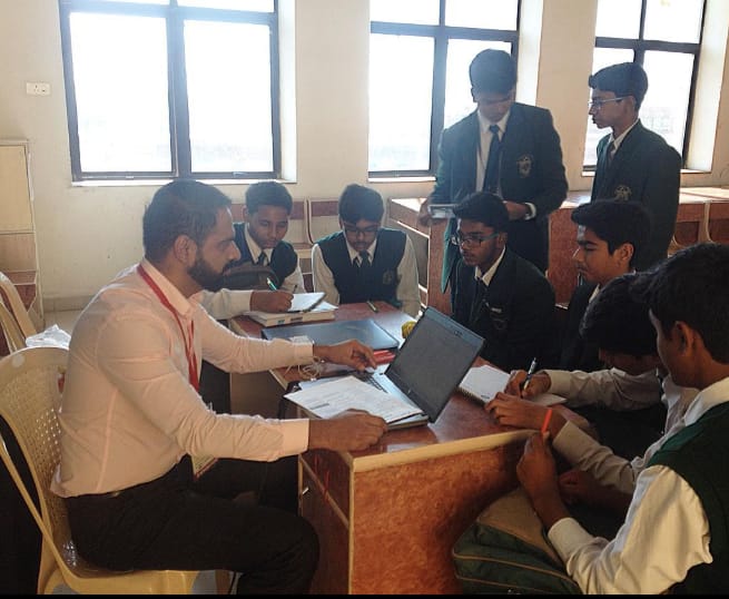 Akram Khan training a group of students in a classroom